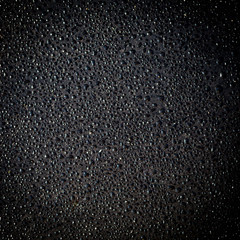 dew drops on a black metallic background