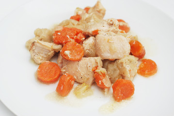 Garnish of Broiled Chicken Carrots with Carrots and Onion Sauce. Selective focus. Homemade Food. Chicken Meat. Isolated.