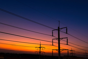 Fototapeta premium Electric lines at sunset evening twilight sky.