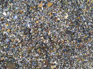 Polished glass pieces in the rocks at Glass Beach near Fort Bragg, California. Top down view.