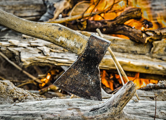 A small fire on the sandy river bank close-up