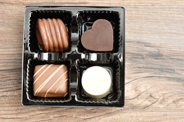 A variety of chocolates displayed in a tray