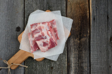 fresh pork ribs on a cutting Board, wooden background