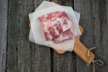 fresh pork ribs on a cutting Board, wooden background