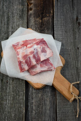 fresh pork ribs on a cutting Board, wooden background