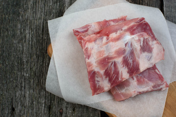 fresh pork ribs on a cutting Board, wooden background
