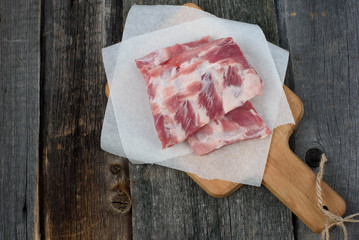 fresh pork ribs on a cutting Board, wooden background