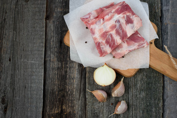 fresh pork ribs on a cutting Board, wooden background