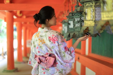 A Japanese woman in summer kimono (yukata) with  traditional lanterns