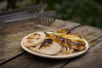 Organic grilled vegetables with peppers and onion on rustic vintage table background