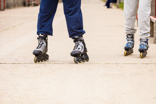 Friends outdoors have fun rollerblading together.