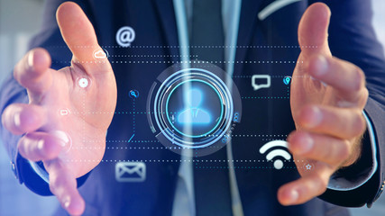 Businessman holding a Contact icon surrounding by app and social icon - 3d render