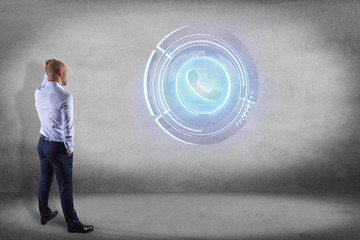 Businessman in front of a wall with a Shinny technologic phone button - 3d render