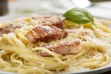 Plate with traditional Italian pasta Carbonara with grated parmesan