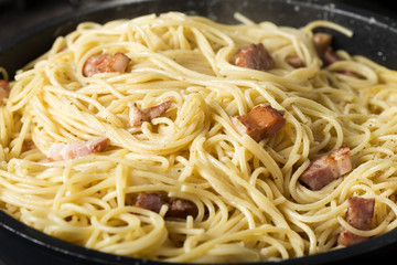 Cooking traditional Italian pasta Carbonara in pan