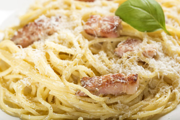 Plate with traditional Italian pasta Carbonara with grated parmesan