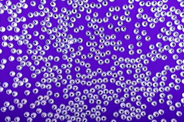 Bright and Shiny Precious Rhinestone Swarovski crystal color on a purple background.