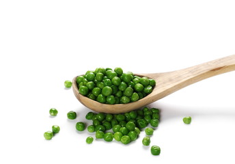 Fresh wet and raw green peas in wooden spoon, vegetable isolated on white