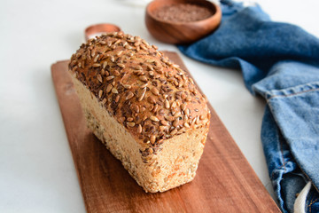Homemade multi-grain bread on a wooden board.
