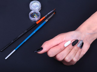 Black, white Nail art manicure. Holiday style bright Manicure with sparkles. Beauty hands. Stylish Nails, Nail Polish