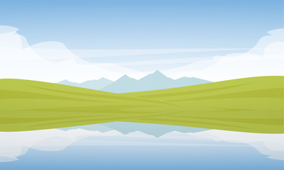 Obraz na płótnie Canvas Mountain Lake landscape with green fields and reflection.
