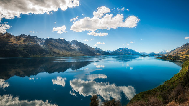 Sun rays at Lake Wakatipu from the scenic road from Queenstown to Glenorchy, New Zealand, South Island