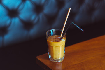 Ice coffee on a wooden table