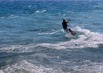 Kitesurfer on the sea wave