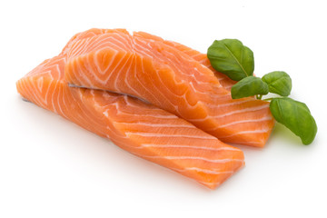 Fresh salmon fillet with basil on the white background.