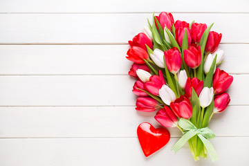 Springt time. Red tulip bouquet on the white wooden background.