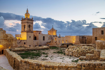 Night view of Citadel, The Cittadella in Maltese, also known as the Gran Castello, a citadel in Victoria, on the island of Gozo in Malta. Popular touristic attraction and destination. - obrazy, fototapety, plakaty