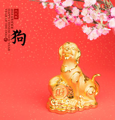 Chinese new year decoration:golden dog statue and gold ingots,translation of calligraphy: 2018 is year of the dog,red stamp: good Fortune for year
