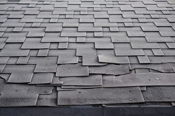 Shingles roof damage covered with frost. Close up view on Asphalt Roofing Shingles Background. Roof Shingles - Roofing.