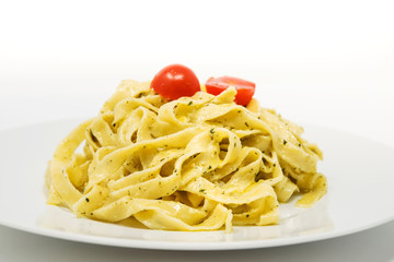 Pasta with pesto sauce and nuts on a the table