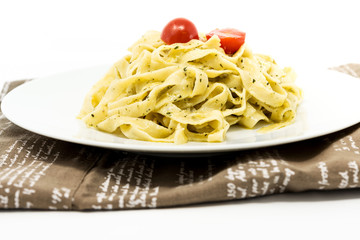 Pasta with pesto sauce and nuts on a the table