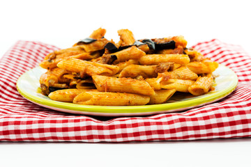 penne with aubergine and tomato sauce on a the table