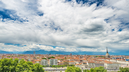 Fototapeta na wymiar Turin Cityscape, Italy, Torino skyline, the Mole Antonelliana towering over the buildings. Wind storm clouds over the Alps in the background.