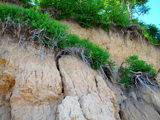 Landslide, rockfall on steep slopes of limestone mountains of northern Black Sea coast. Zone of natural disasters during rainy season. Large masses of earth slip along slope of hill, destroy houses