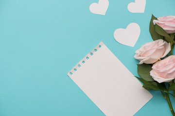 Obraz premium Mother's Day concept. Pink roses with gift box and lipstick. Open notebook for copy space.
