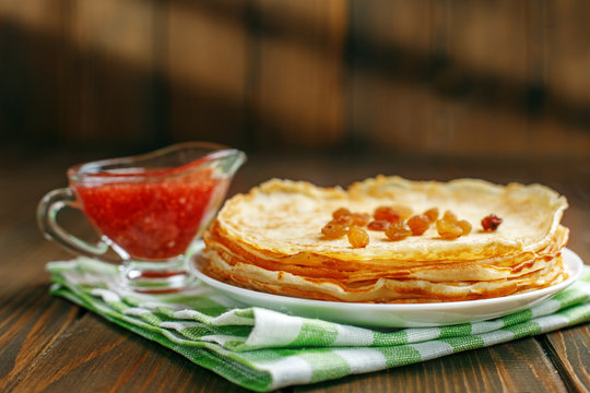Traditional Ukrainian or Russian pancakes with raisins and jam.The concept of food, breakfast,  pancake week.