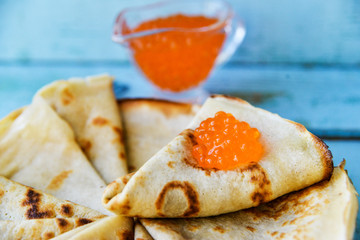Russian Maslenitsa, pancakes with red caviar. Shrovetide, pancake week, carnival, shrove, pancake day