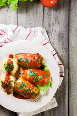 Stuffed cabbage with meat and rice served with boiled potatoes and tomato sauce