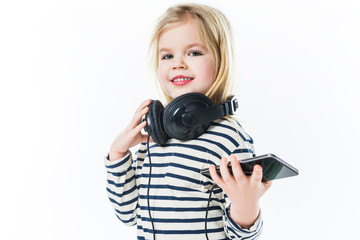 beautiful little child with headphones and smartphone isolated on white