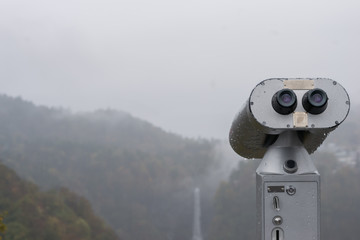 Public Binoculars Machine with the fog in Autumn at Akechidaira Ropeway ,Nikko in Japan