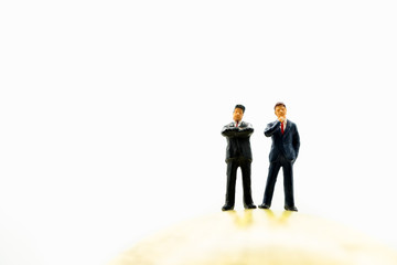 Fototapeta premium Miniature people, couple businessman standing on earth using as business management and teamwork concept