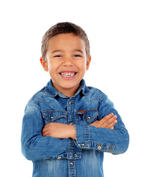 Funny small child with dark hair and black eye crossing his arms