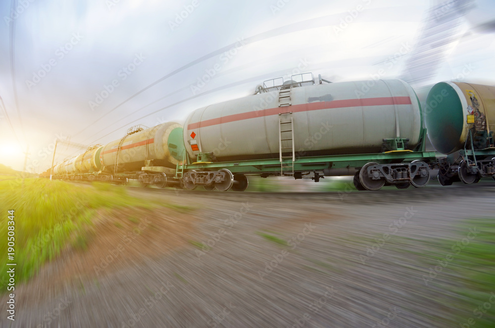 Poster freight train passing oil-loading, fuel oil, fuel tanks in motion.