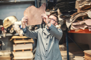 business manager at leather shoe factory doing various daily tasks