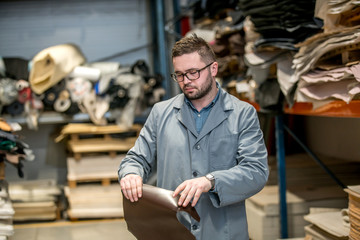 business manager at leather shoe factory doing various daily tasks