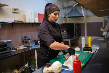 woman Cook prepares food sushi kitchen